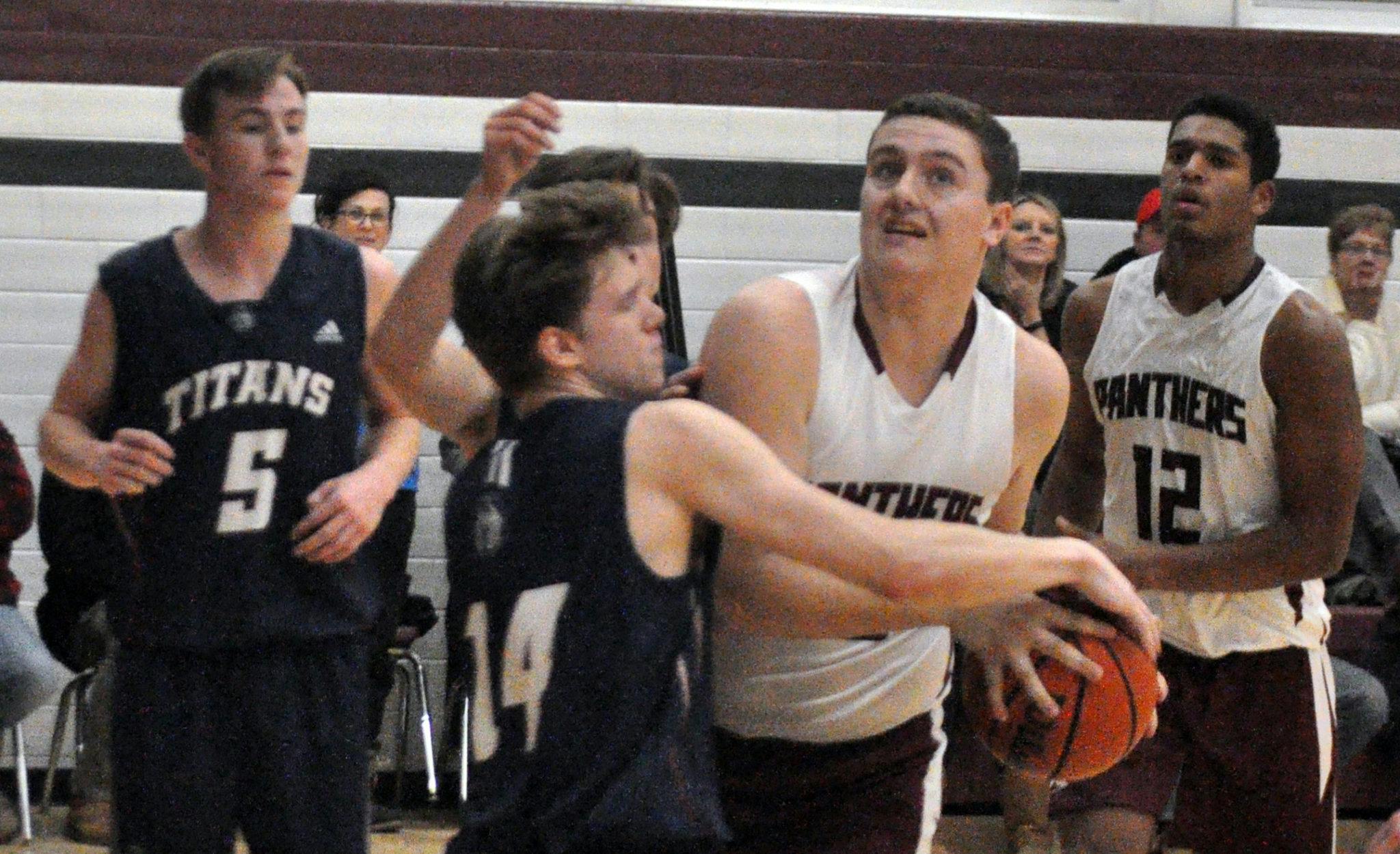 <p>Close contest &#8211; St. Theresa Titan Bailey Maracle tries to steal the ball from PECI Panther Brodie Byford Thursday as St. Theresa&#8217;s Aden Callahan and PECI&#8217;s Alex Arsenault look on. (Adam Bramburger/Gazette staff)</p>
